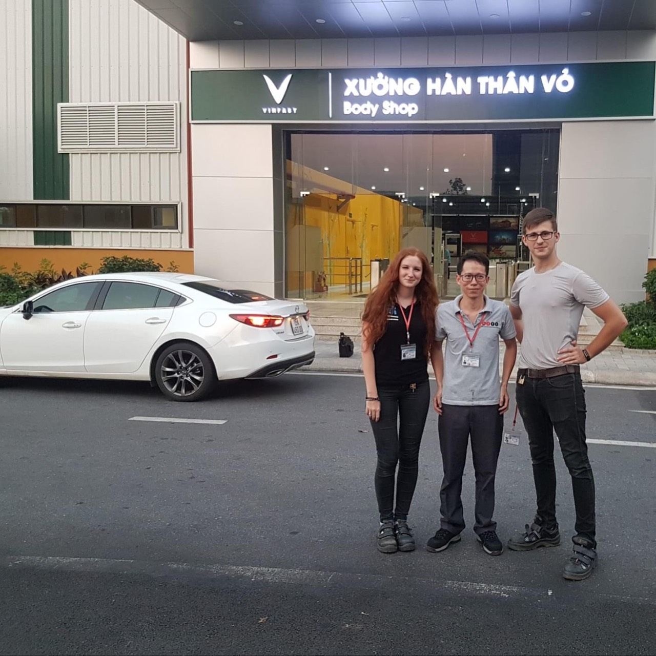 ATTS member with foreign colleagues outside VinFast Body Shop